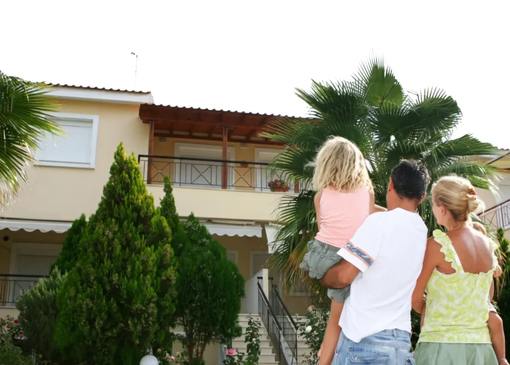 Family standing in front of their new home, excited about their first home loan purchase in Perth