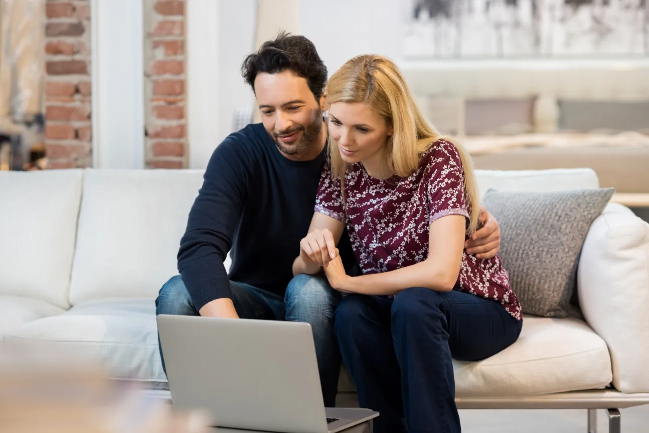 Couple researching home loan options online, planning their first property purchase